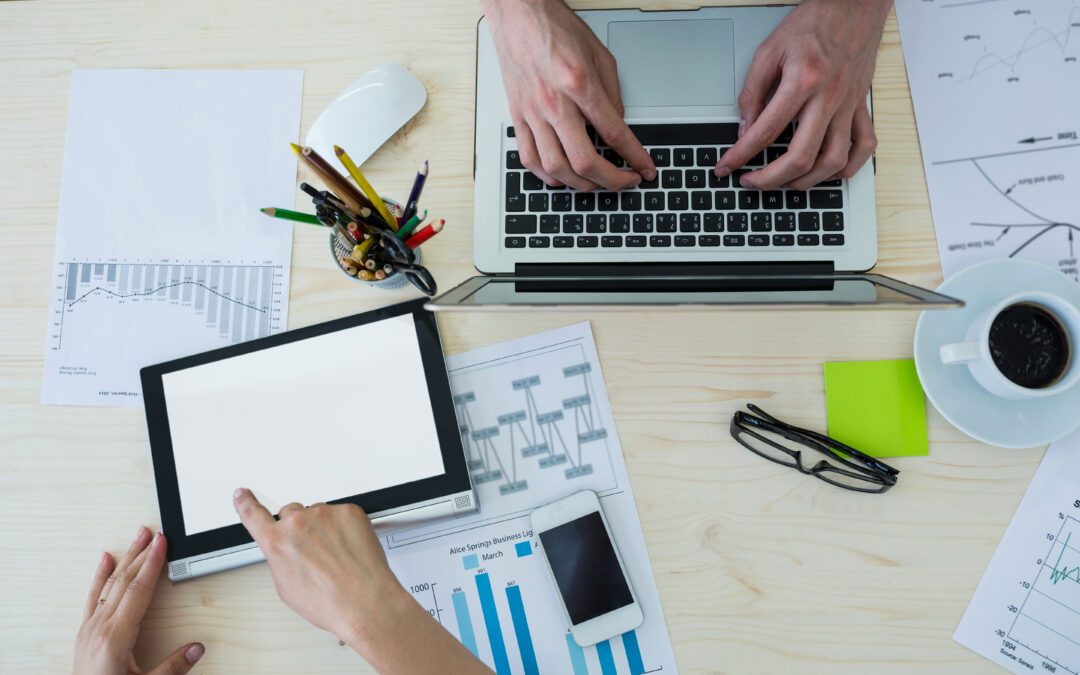 Hands typing on laptops